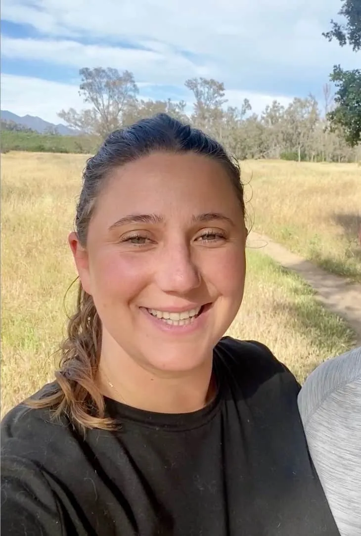 A headshot of Angela smiling